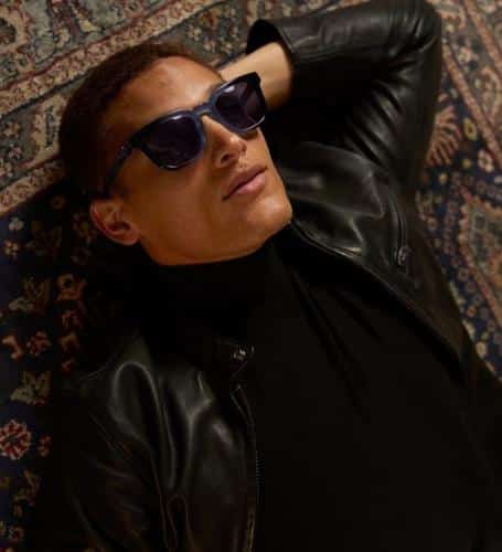 Man in leather jacket with luxury brand sunglasses